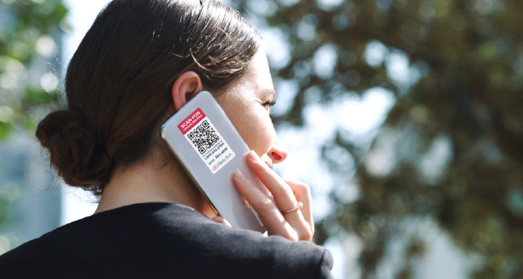 Women holding a phone with QR code sticker