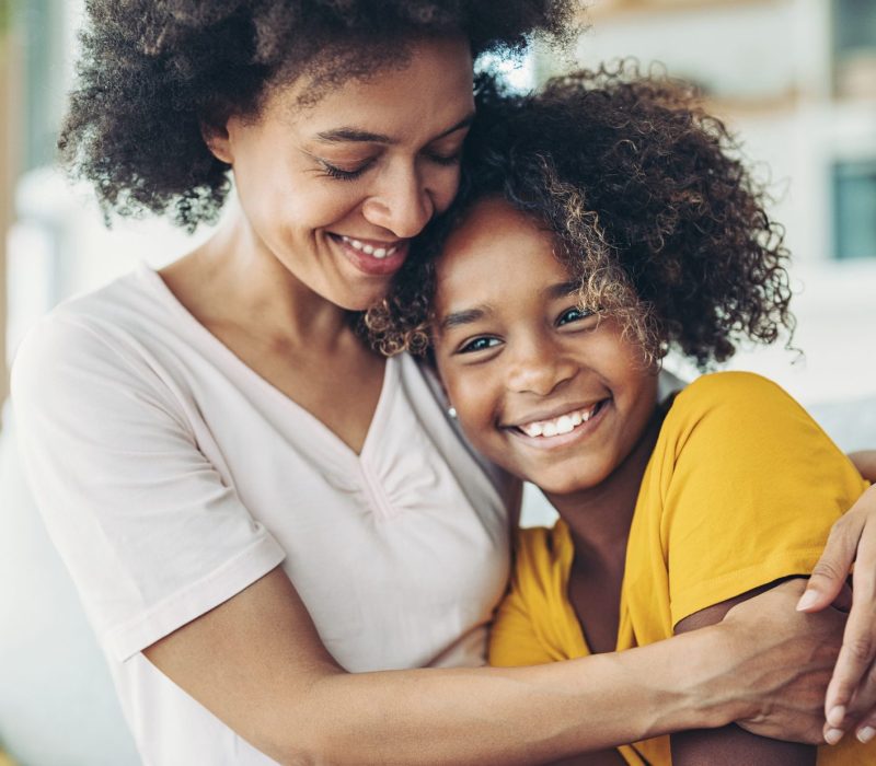 Smiling mother embracing her daughter